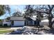 Attractive one-story home with a two-car garage, mailbox, and tidy landscaping at 2900 Woodpine Ct, Sarasota, FL 34231