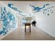 Spacious game room with a foosball table and unique wall mural perfect for entertaining guests at 2900 Woodpine Ct, Sarasota, FL 34231