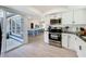 Open-concept kitchen with stainless steel appliances and adjacent dining area, perfect for entertaining at 2900 Woodpine Ct, Sarasota, FL 34231