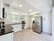 Well-lit kitchen featuring stainless steel appliances, white cabinets, and modern countertops at 2900 Woodpine Ct, Sarasota, FL 34231