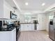 Bright kitchen features stainless steel appliances, black countertops, and white cabinetry at 2900 Woodpine Ct, Sarasota, FL 34231
