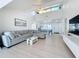 Inviting living room features an open floor plan, a large sectional sofa, and stylish coastal accents at 2900 Woodpine Ct, Sarasota, FL 34231