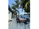 Outdoor patio featuring a dining table and chairs, with a grill, perfect for entertaining and outdoor living at 2900 Woodpine Ct, Sarasota, FL 34231