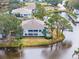 Aerial view of a condo community located on a canal with mature trees and well-manicured lawns at 312 108Th W St, Bradenton, FL 34209