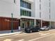 Modern building exterior with wood paneling and sleek design, complemented by well-maintained landscaping at 430 Kumquat Ct # 306, Sarasota, FL 34236