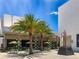 Courtyard featuring modern design with palm trees, a sculpture, and inviting outdoor seating areas at 430 Kumquat Ct # 306, Sarasota, FL 34236