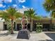 Courtyard featuring palm trees, an art sculpture, and the Overton building in the background at 430 Kumquat Ct # 306, Sarasota, FL 34236