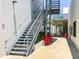 Modern steel staircase leading to upper levels, complemented by colorful seating and lush greenery at 430 Kumquat Ct # 306, Sarasota, FL 34236