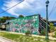 A creatively painted building with a mural and contrasting black and white stripes, enhancing urban appeal at 430 Kumquat Ct # 306, Sarasota, FL 34236