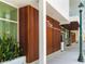 Contemporary building featuring sleek wood paneling, an inviting entrance, and stylish modern design elements at 430 Kumquat Ct # 406, Sarasota, FL 34236