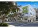 Well-maintained building with awnings and lush trees along a street at 430 Kumquat Ct # 406, Sarasota, FL 34236