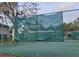 Signage at Hidden Hollow, a townhome condominium, with tennis courts in the background at 4412 Sandner Dr # 4412, Sarasota, FL 34243