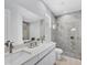Bright bathroom with double sink vanity, quartz countertop, and a marble tiled walk-in shower at 4529 Crowell Ln, North Port, FL 34288