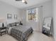 Bedroom with a large window offering natural light, a ceiling fan, and neutral decor at 4529 Crowell Ln, North Port, FL 34288
