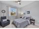 Bedroom features a large window with sheer curtains, a ceiling fan, and decoratively themed accents at 4529 Crowell Ln, North Port, FL 34288