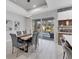Bright dining area features pool views, modern light fixture, and seating for six at 4529 Crowell Ln, North Port, FL 34288