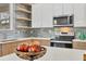 A well-designed kitchen with quartz countertops, modern appliances, wood cabinets, and stylish backsplash at 4529 Crowell Ln, North Port, FL 34288