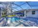 A screened pool with a sun umbrella, chairs, and a paved patio that offers a resort-style experience at 4529 Crowell Ln, North Port, FL 34288