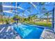 Sparkling pool surrounded by lush landscaping and a screened enclosure at 4529 Crowell Ln, North Port, FL 34288