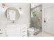 Bathroom featuring white vanity, modern lighting, and sleek glass-enclosed shower at 4620 Riverview Blvd, Bradenton, FL 34209