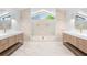 Modern primary bathroom featuring marble floors, double vanity, and a large glass-enclosed shower at 4620 Riverview Blvd, Bradenton, FL 34209