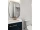 Bathroom featuring a single vanity sink with dark cabinets, mirror and toilet at 4620 Riverview Blvd, Bradenton, FL 34209