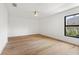 Bright bedroom with hardwood floors and a large window view to the outside at 4620 Riverview Blvd, Bradenton, FL 34209