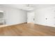 Bright bedroom with hardwood floors, ceiling fan, ensuite bathroom, closet and view to the entry foyer at 4620 Riverview Blvd, Bradenton, FL 34209
