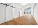 Spacious bedroom features hardwood floors, closet with barn door and water view at 4620 Riverview Blvd, Bradenton, FL 34209