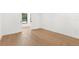 Bedroom with hardwood floors, neutral walls, and bright window at 4620 Riverview Blvd, Bradenton, FL 34209