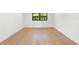Bedroom features hardwood floors, neutral walls, and bright window at 4620 Riverview Blvd, Bradenton, FL 34209