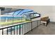 View from the enclosure to the pool, spa, outdoor space, boat dock and the bay at 4620 Riverview Blvd, Bradenton, FL 34209