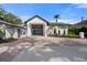 Luxurious home features sleek architectural design, brick driveway, and well-manicured tropical landscaping at 4620 Riverview Blvd, Bradenton, FL 34209