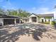 Modern white home featuring a three car garage and expansive brick driveway at 4620 Riverview Blvd, Bradenton, FL 34209