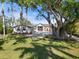 Stunning modern home with a large shade tree, lush lawn, and ample parking at 4620 Riverview Blvd, Bradenton, FL 34209