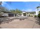Bright home showcasing an attached three car garage and long brick driveway at 4620 Riverview Blvd, Bradenton, FL 34209