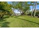 Lush front lawn showcasing a modern home design and mature shade trees at 4620 Riverview Blvd, Bradenton, FL 34209