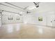 A large, bright garage with high ceilings, ample lighting, and three windows at 4620 Riverview Blvd, Bradenton, FL 34209