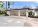 The exterior of a three car garage with automatic doors and updated lighting at 4620 Riverview Blvd, Bradenton, FL 34209