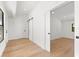 Hallway with hardwood floors, neutral walls, and sliding barn door at 4620 Riverview Blvd, Bradenton, FL 34209