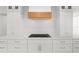 Modern kitchen features sleek white cabinetry, stainless steel appliances and a wood paneled range hood at 4620 Riverview Blvd, Bradenton, FL 34209