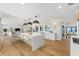 Open kitchen featuring an oversized island, modern lighting, and hardwood floors at 4620 Riverview Blvd, Bradenton, FL 34209