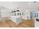 Open kitchen boasts an expansive island, modern lighting, and seamless transition to outdoor living at 4620 Riverview Blvd, Bradenton, FL 34209
