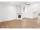 Bright living room features a modern fireplace and light hardwood floors at 4620 Riverview Blvd, Bradenton, FL 34209