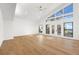 Spacious living room with large windows, vaulted ceiling, and wood floors at 4620 Riverview Blvd, Bradenton, FL 34209