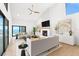Modern living room with a fireplace, hardwood floors, and waterfront views at 4620 Riverview Blvd, Bradenton, FL 34209