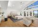 Bright main bedroom featuring a waterfront view, high ceilings and hardwood floors at 4620 Riverview Blvd, Bradenton, FL 34209