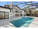 Beautiful pool and spa with screened enclosure plus view of the home's exterior at 4620 Riverview Blvd, Bradenton, FL 34209