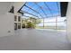 Screened outdoor pool and patio with view of backyard landscaping and waterfront at 4620 Riverview Blvd, Bradenton, FL 34209
