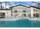 Gorgeous screened-in pool and patio area with plenty of room for entertaining and a hot tub at 4620 Riverview Blvd, Bradenton, FL 34209